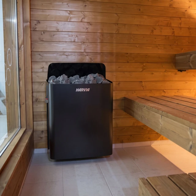 Wood-fired Harvia heater with stones, inside the sauna