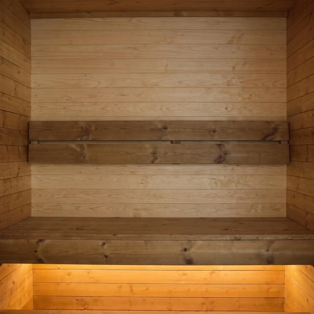 The back wall in light sauna panelling above the upper bench
