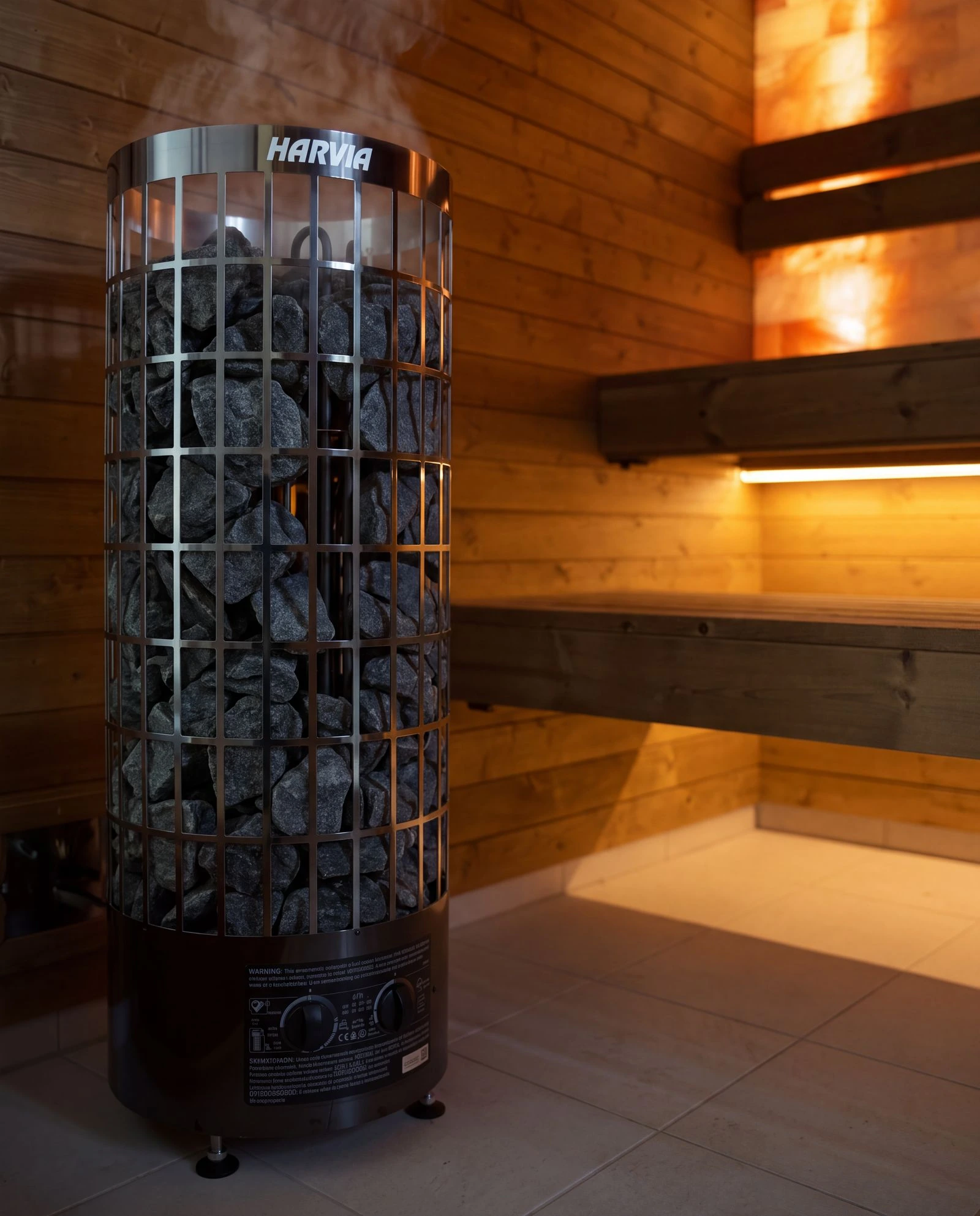 Harvia heater with stones, with benches and LED light in the background